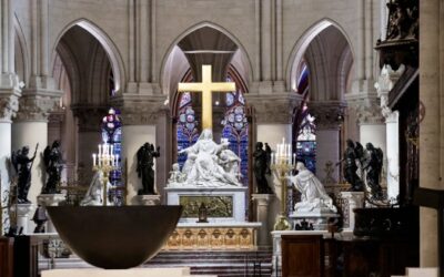 Cathedral interior with statues and stained glass.