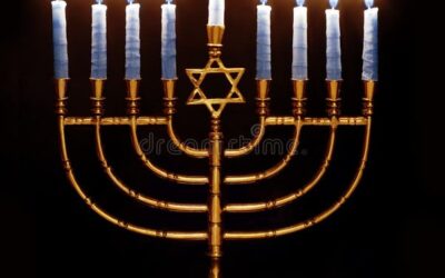 Lit menorah with eight blue candles glowing.