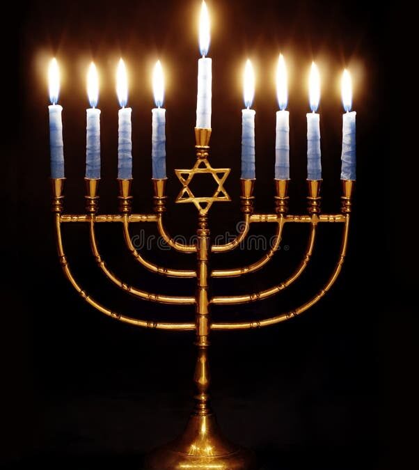 Lit menorah with eight blue candles glowing.