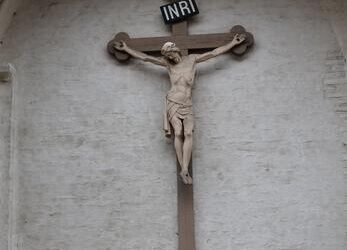 Crucifix with "INRI" inscription on wall.